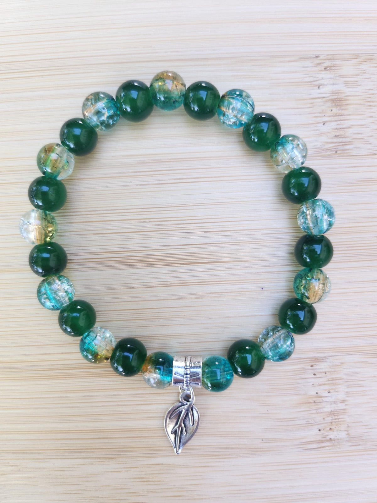 Bracelet en perles vertes et bleutées avec breloque feuille,